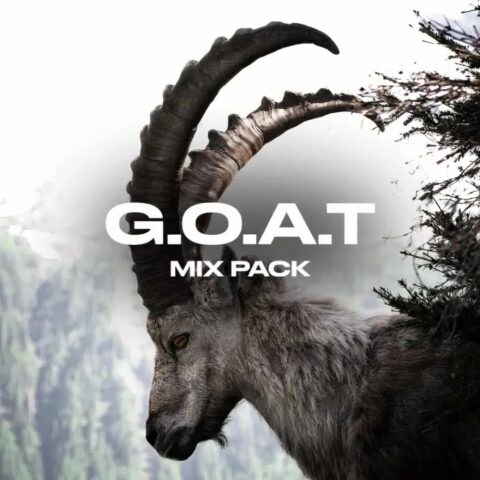 a goat with horns next to a tree